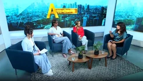 Four women discussing on a talk show set