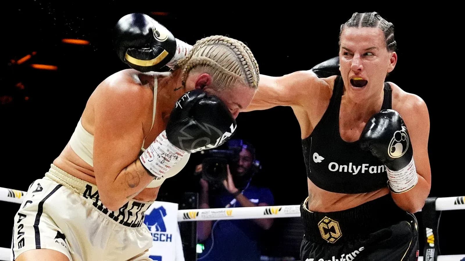 Two female boxers competing in a match