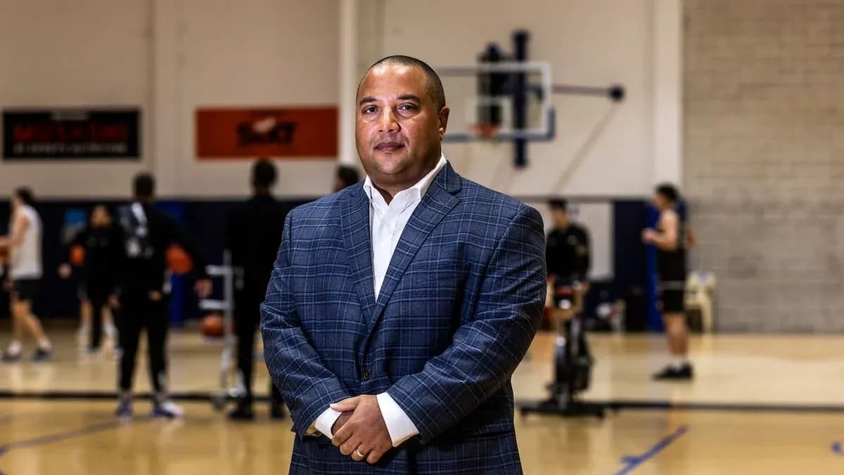 Man in suit standing in basketball training facility