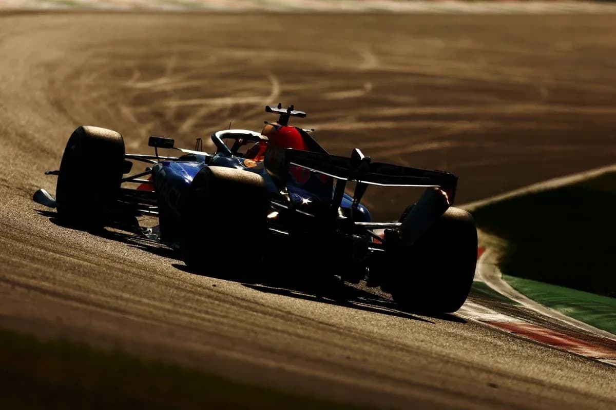 Formula 1 car racing on track during sunset