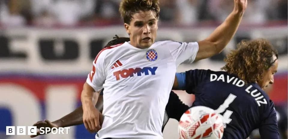Player in white shirt challenging opponent during match