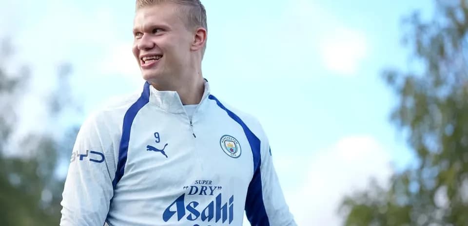 Player smiling during training session in Manchester City kit