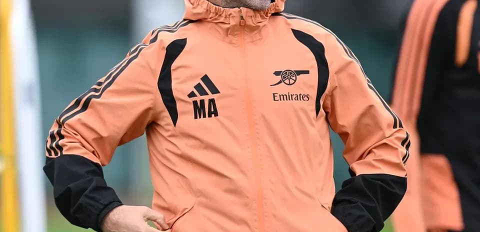 Coach in training jacket smiling during session