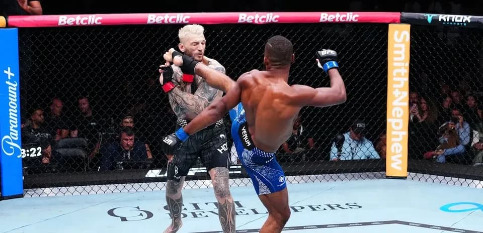 Two fighters engaging in an MMA match inside the octagon