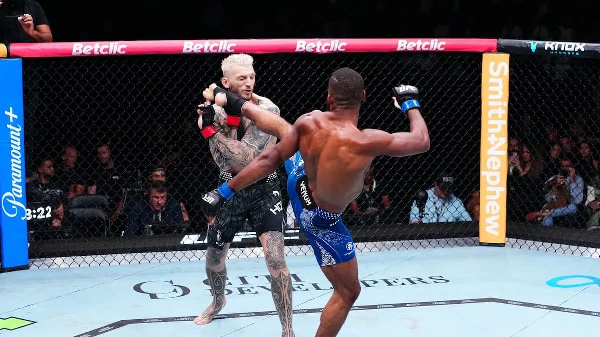 Two fighters engaging in an MMA match inside the octagon