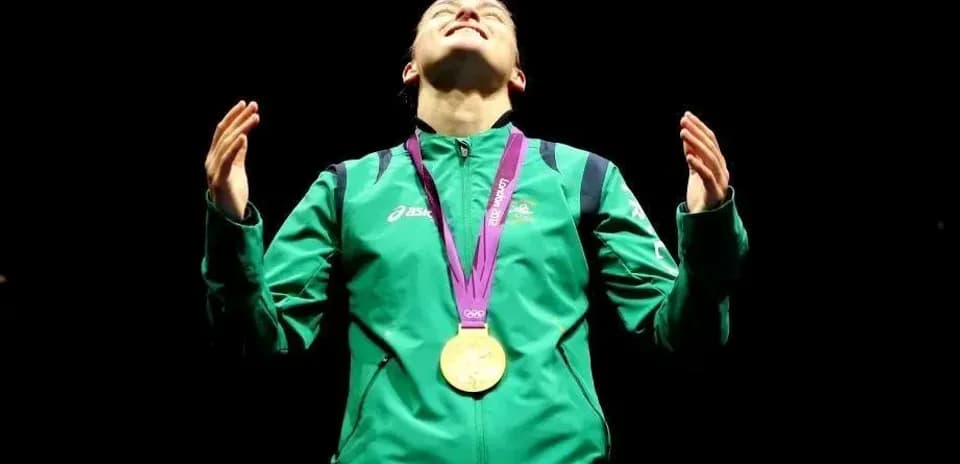 Athlete celebrating with gold medal during ceremony