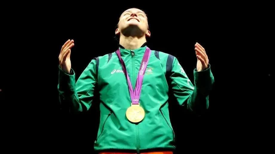 Athlete celebrating with gold medal during ceremony