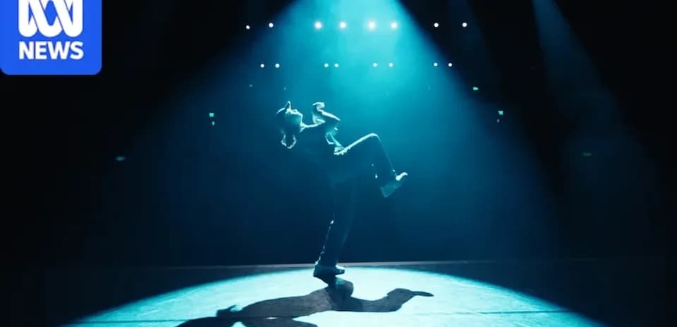 Dancer performing under spotlight on stage