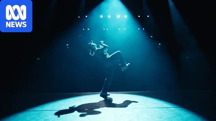 Dancer performing under spotlight on stage