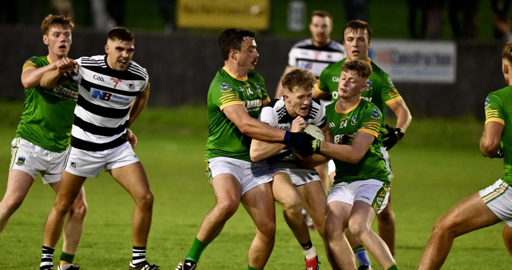 Players competing for possession during a GAA match