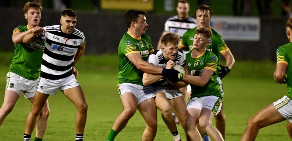 Players competing for possession during a GAA match
