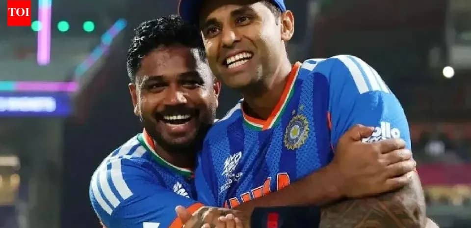 Two cricket players celebrating together on field