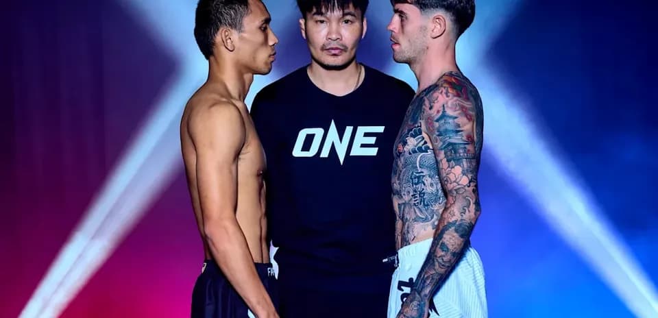 Two fighters facing each other with referee between