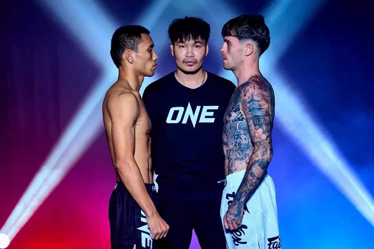 Two fighters facing each other with referee between