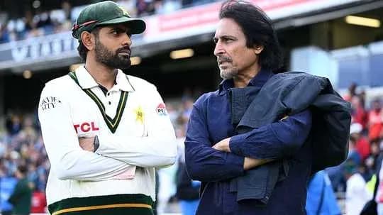 Two men discussing on cricket field sidelines