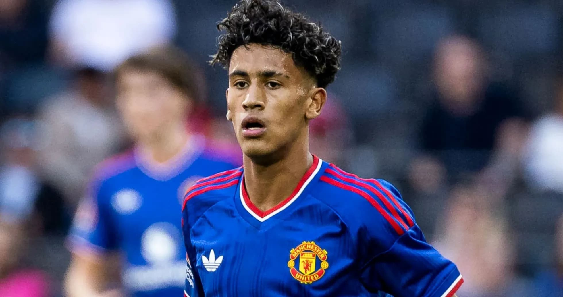 Young player wearing Manchester United jersey on field