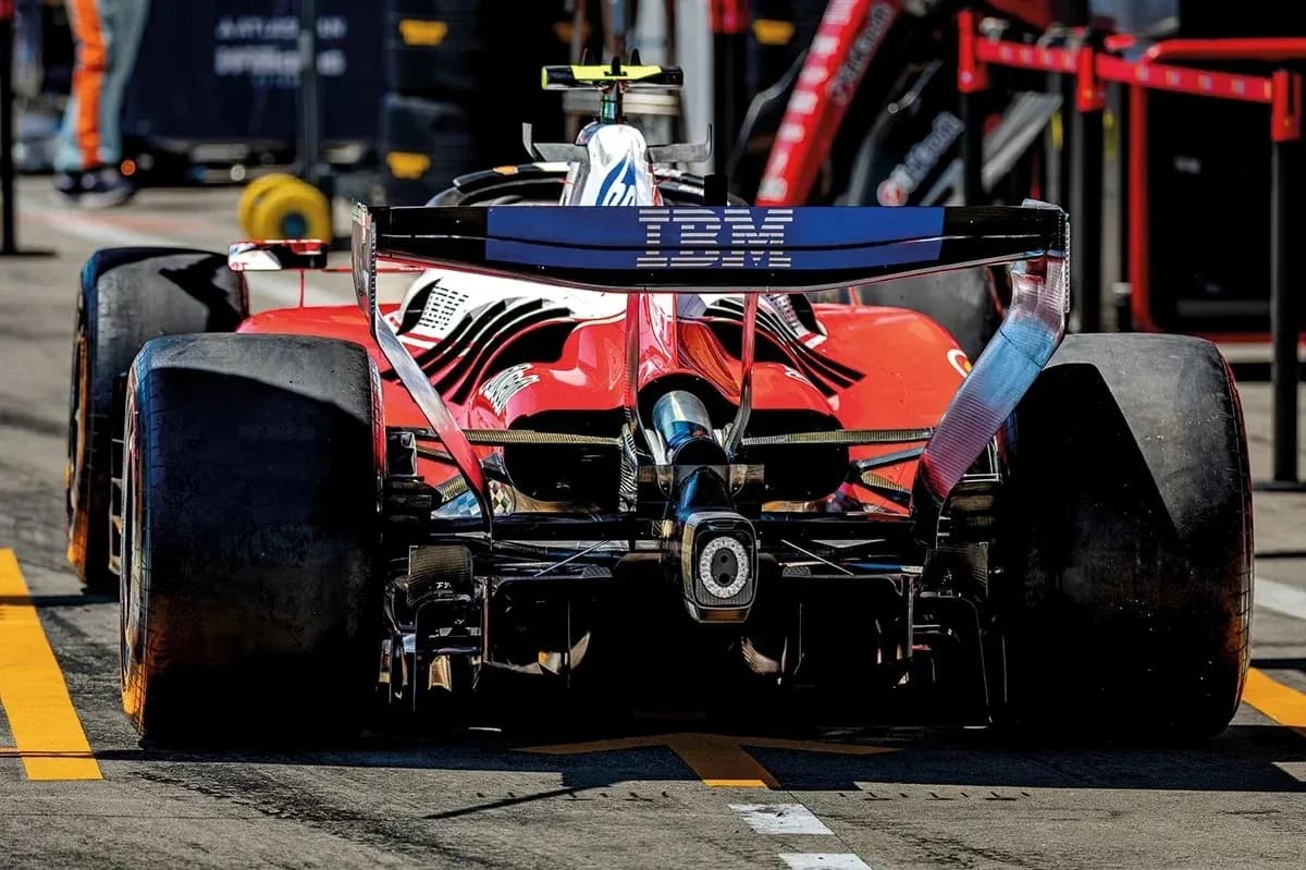 Rear view of red Formula 1 car in pit lane