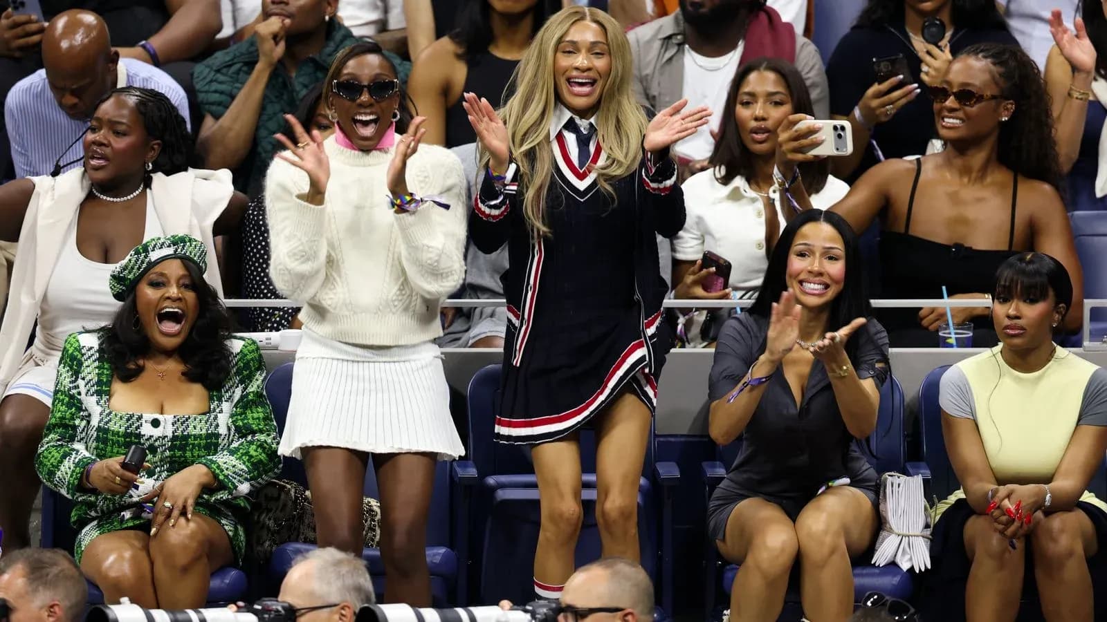 Excited spectators cheering at tennis match
