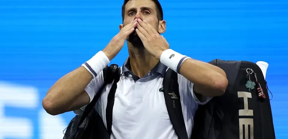 Tennis player blowing kisses while leaving court