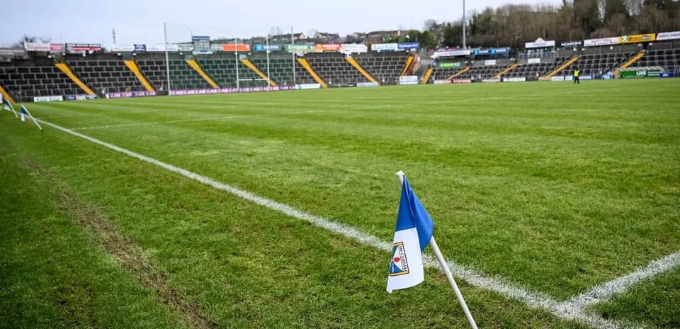 Corner flag on a football pitch with empty stands