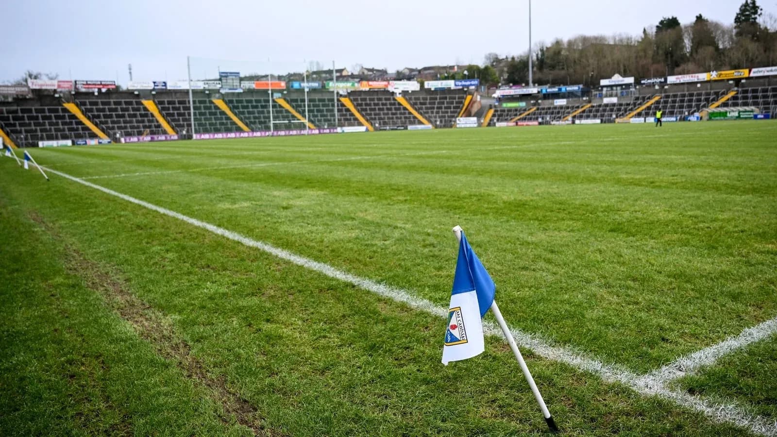 Corner flag on a football pitch with empty stands