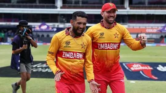 Two Zimbabwean players celebrating on the field