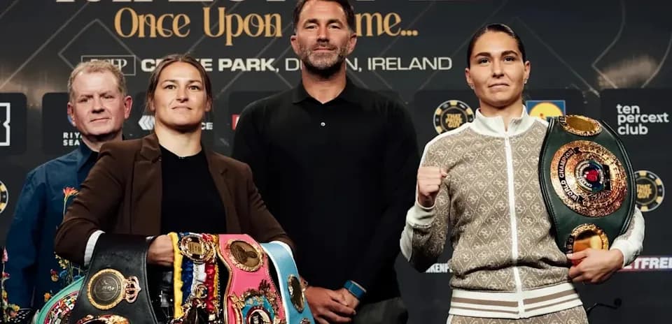 Two boxers posing with championship belts at press event