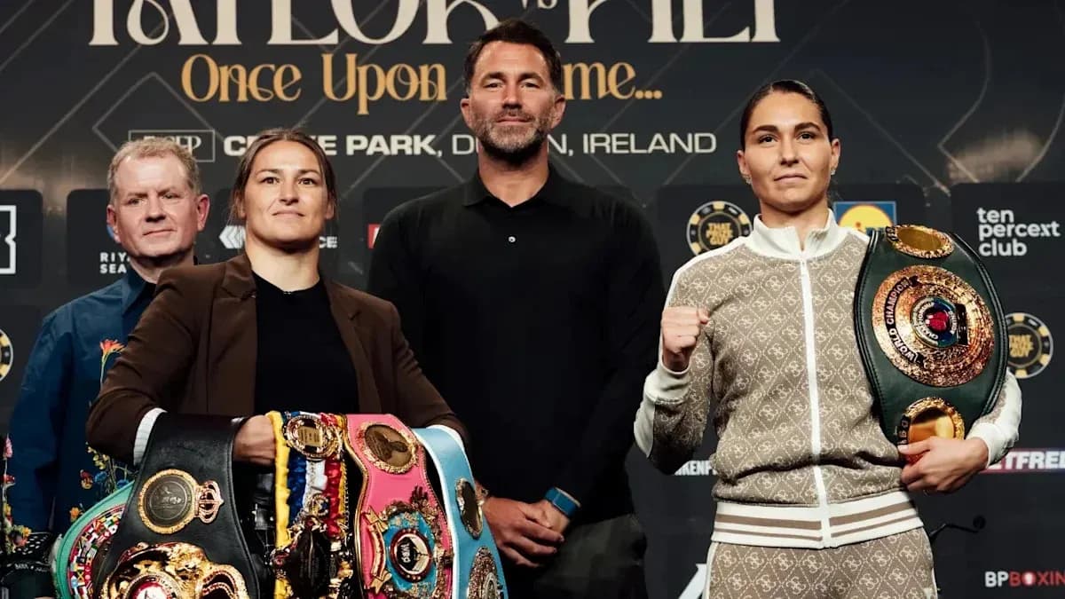 Two boxers posing with championship belts at press event