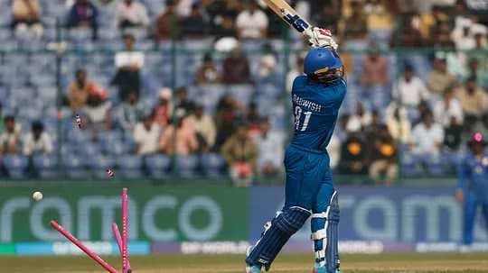 Batsman hitting the ball, wicket is broken