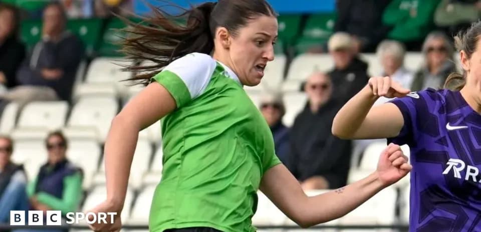 Player in green kicking the ball during match