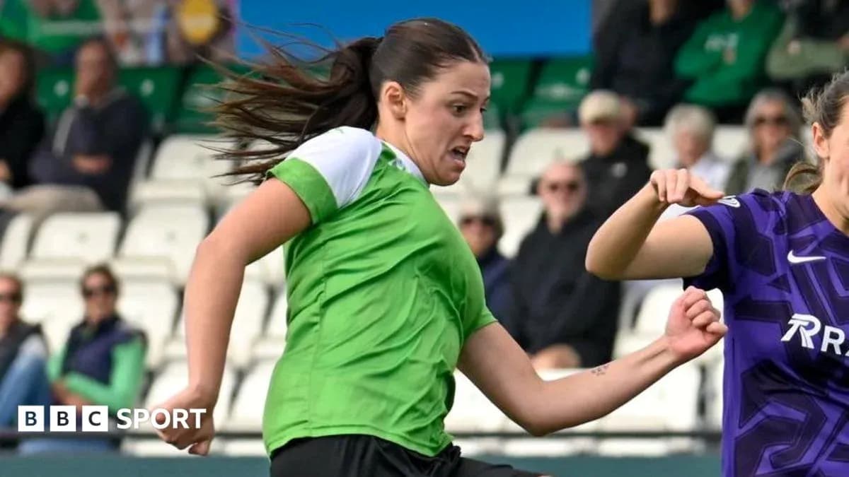 Player in green kicking the ball during match