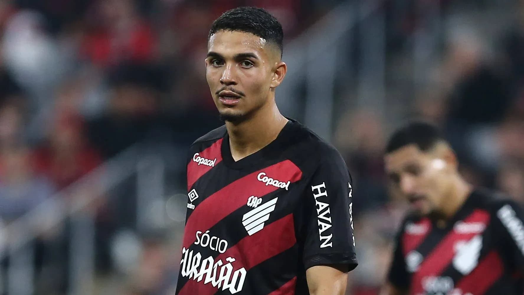 Player in red and black jersey during match