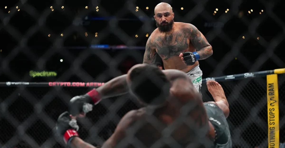 Fighter standing over opponent on the mat in UFC match