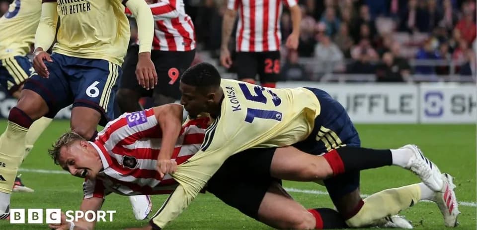 Players competing for the ball on the ground