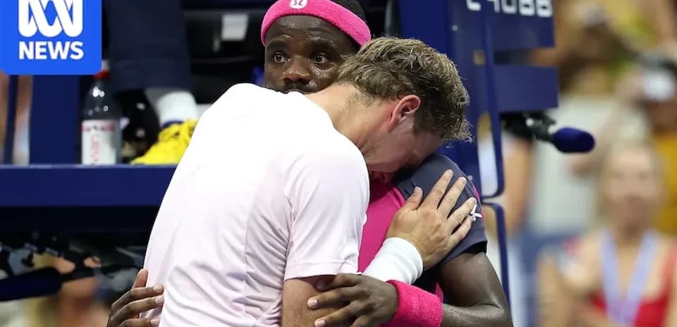 Players embracing during a tennis match celebration
