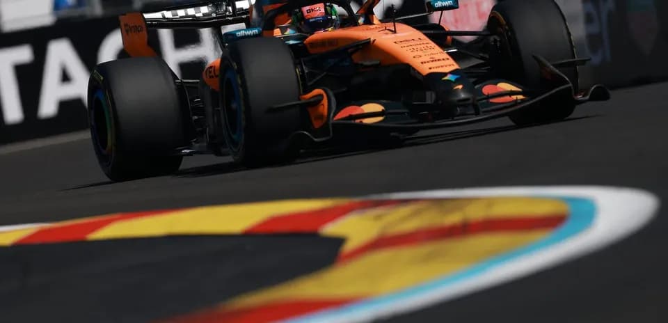 McLaren Formula 1 car navigating a racetrack corner