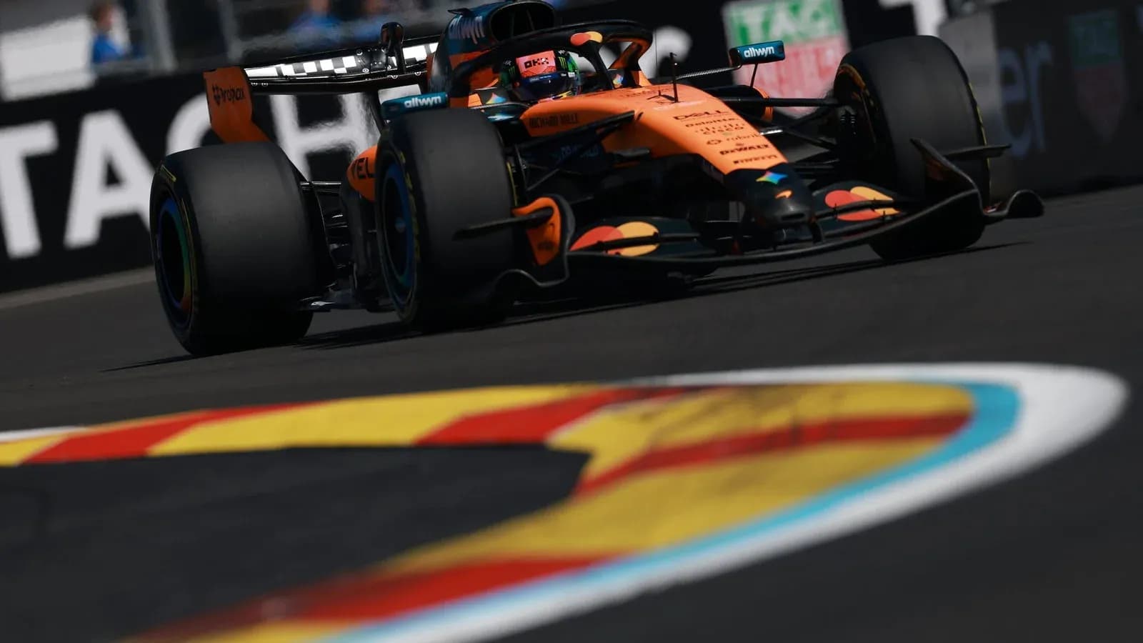 McLaren Formula 1 car navigating a racetrack corner