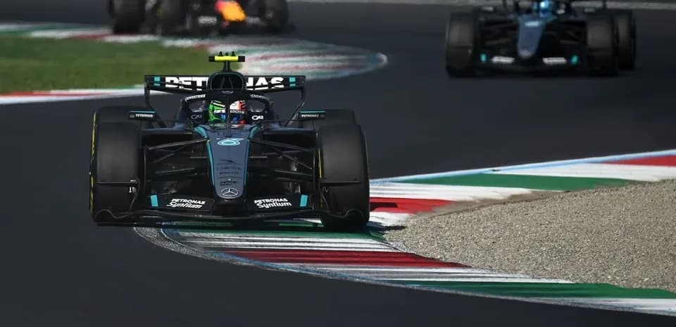 Mercedes driver navigating a turn on racetrack