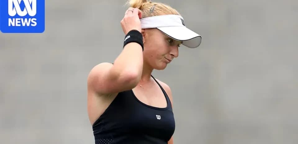 Tennis player adjusting cap during a match