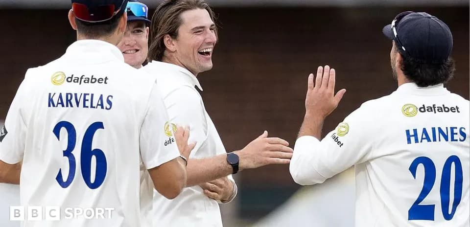Cricket players celebrating a wicket together