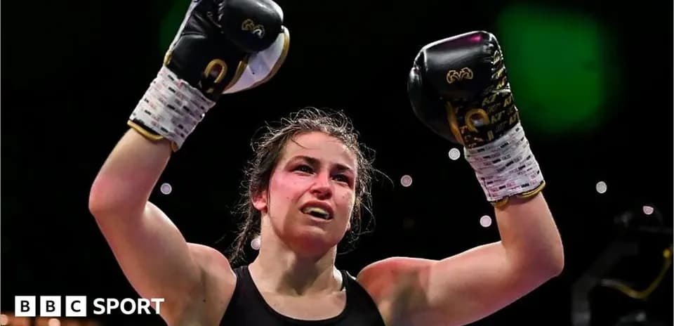 Female boxer celebrating victory with raised gloves