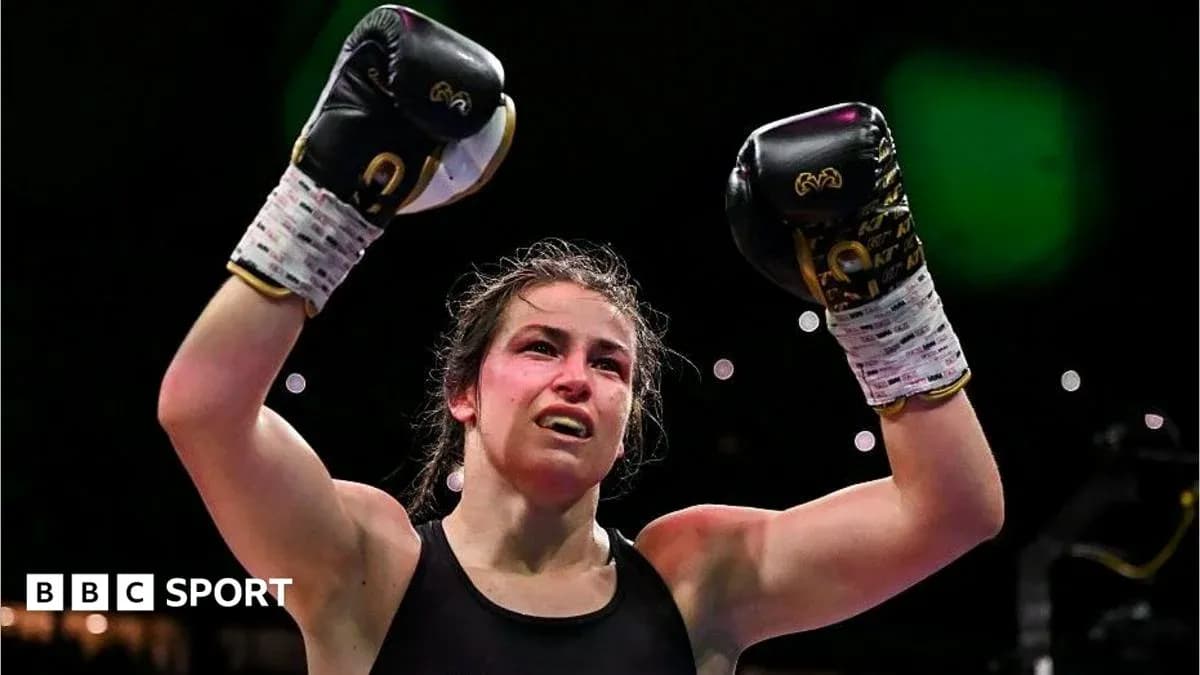 Female boxer celebrating victory with raised gloves