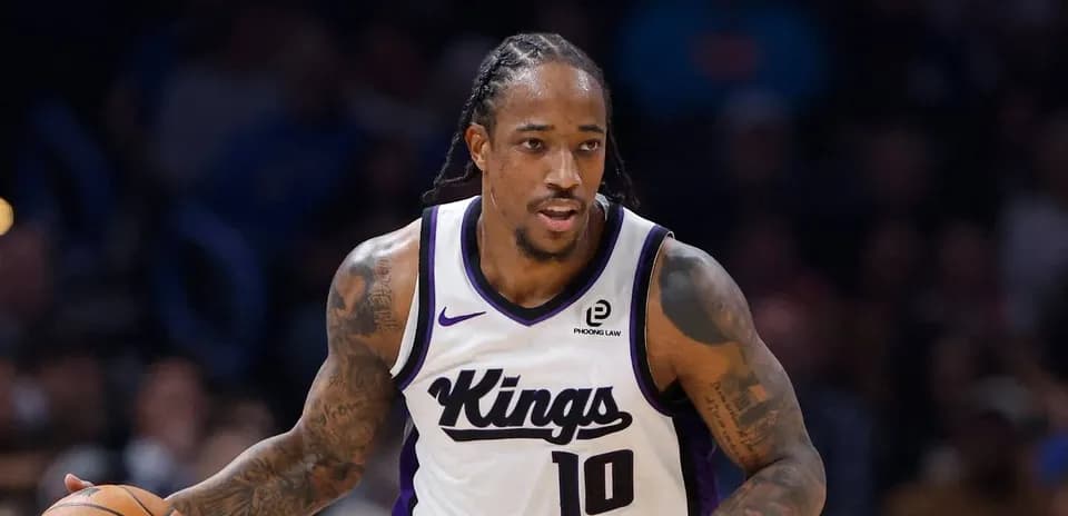 Player dribbling basketball during game for Kings