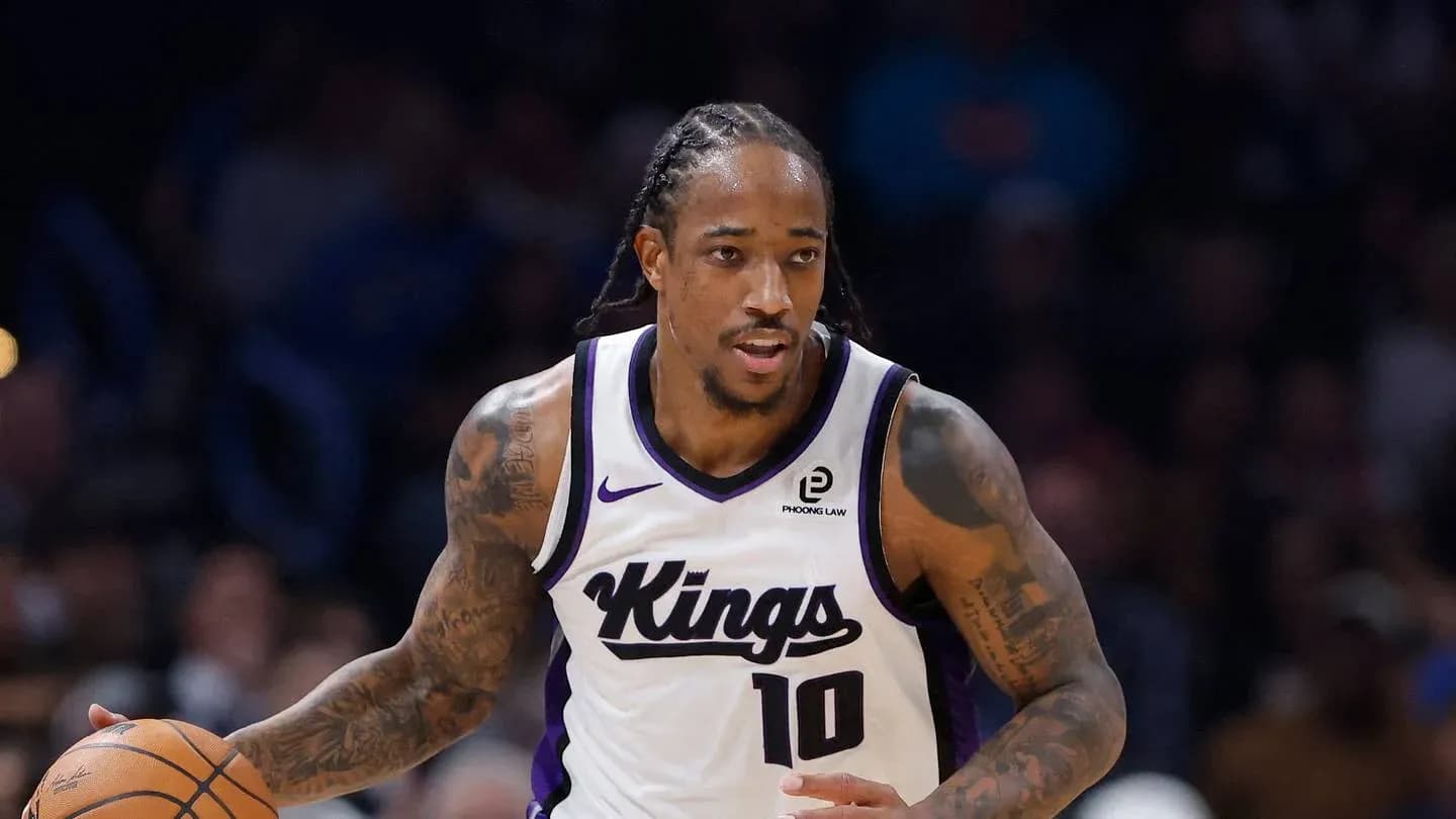 Player dribbling basketball during game for Kings