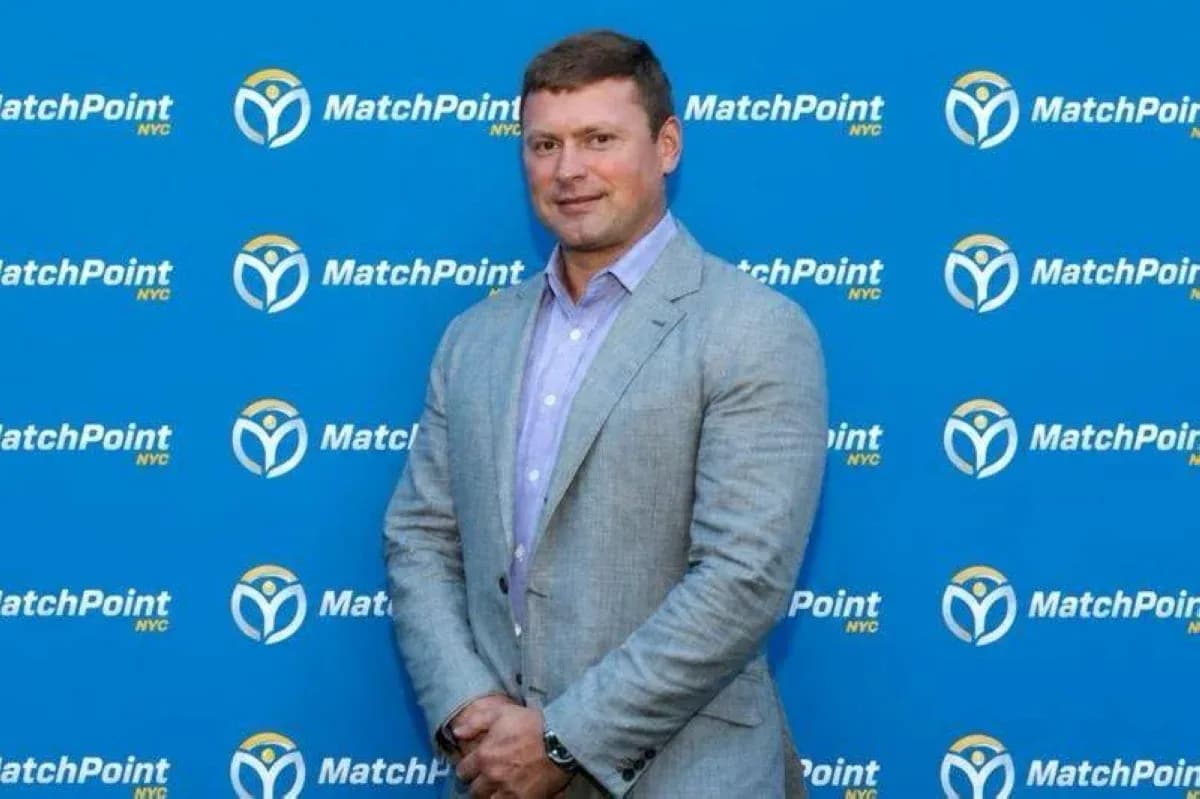 Individual posing in front of MatchPoint NYC backdrop