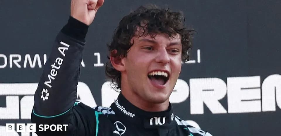 Driver celebrating with raised fist on podium