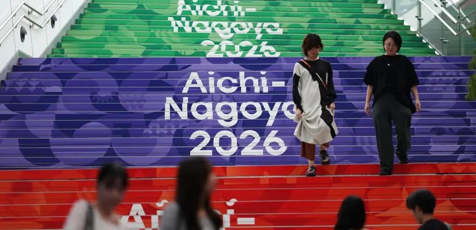People walking down colorful stairs with Aichi-Nagoya 2026