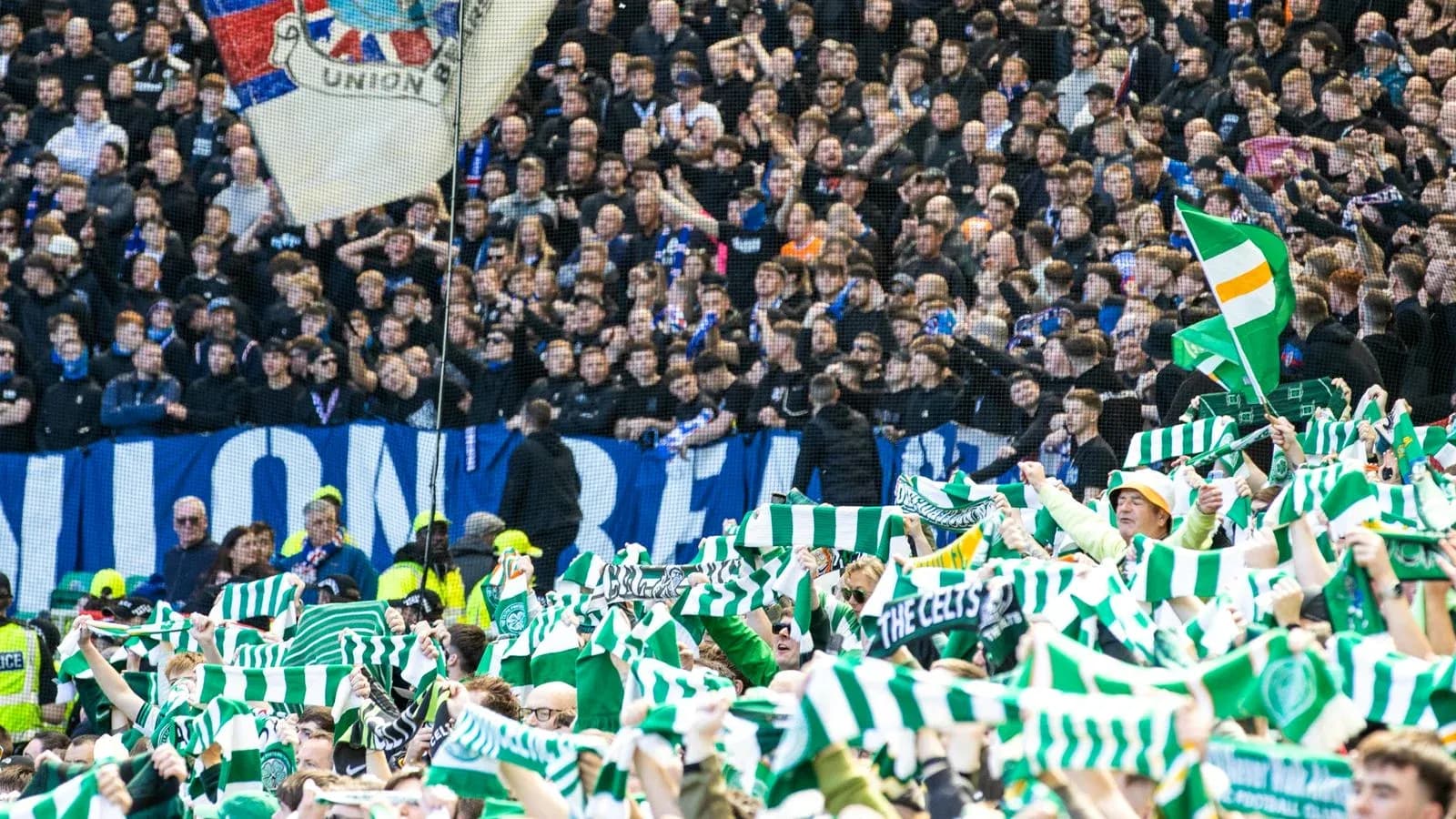 Fans waving scarves during a football match