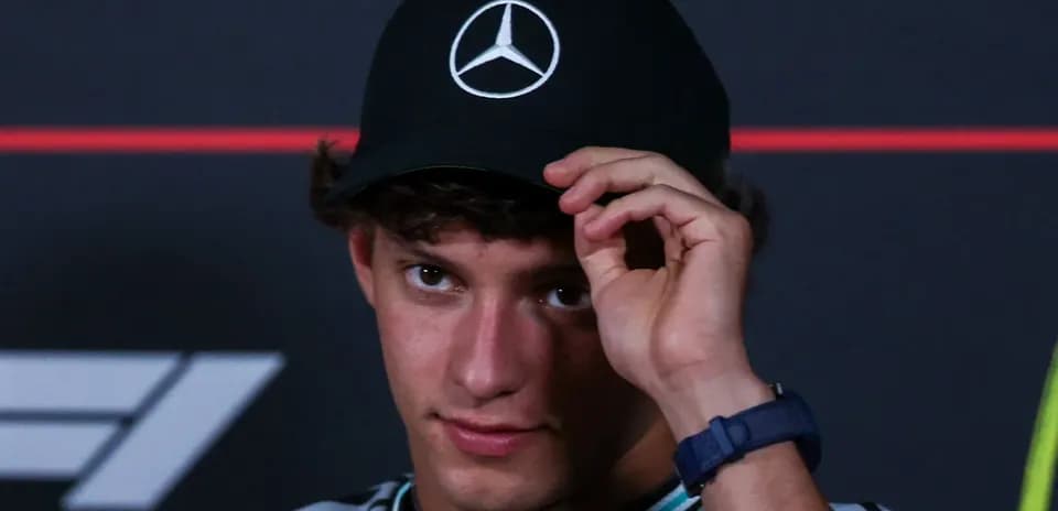Young man adjusting cap during press event
