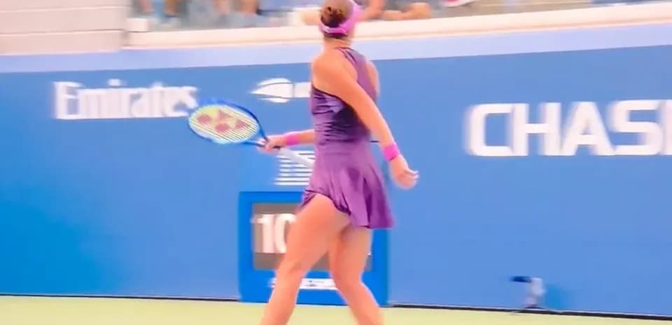 Female tennis player preparing to serve on court
